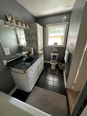 an empty room with windows and cabinet