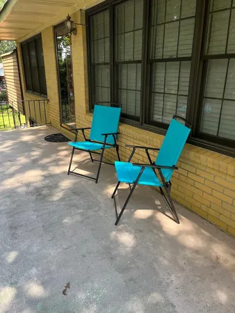 a backyard of a house with table and chairs