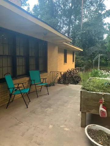 a view of a lake with a table and chairs