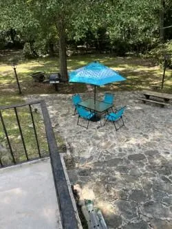 a view of a house with backyard and sitting area
