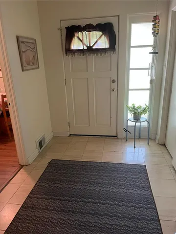 a view of a room with wooden floor and a window
