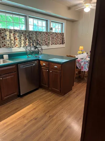 a room with a wooden floor and a bathroom