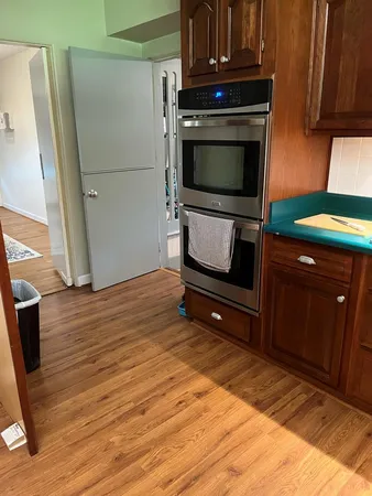 a living room with a wooden floor and a fireplace