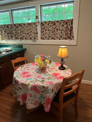 a bed sitting in a bedroom next to a window with a wooden floor