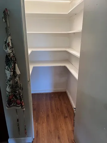 a view of a room with wooden floor