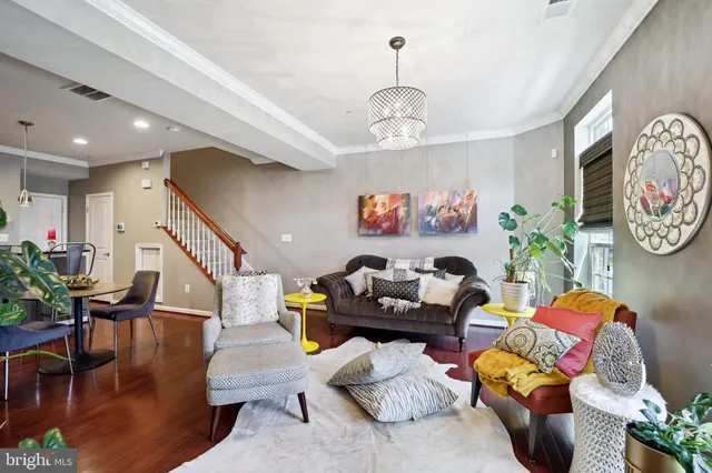 a living room with furniture and a chandelier