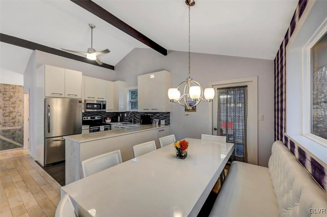 108 Sterling Circle Bushkill, PA 18324 - Photo 18 of 51 a large white kitchen with a large window a refrigerator and stainless steel appliances