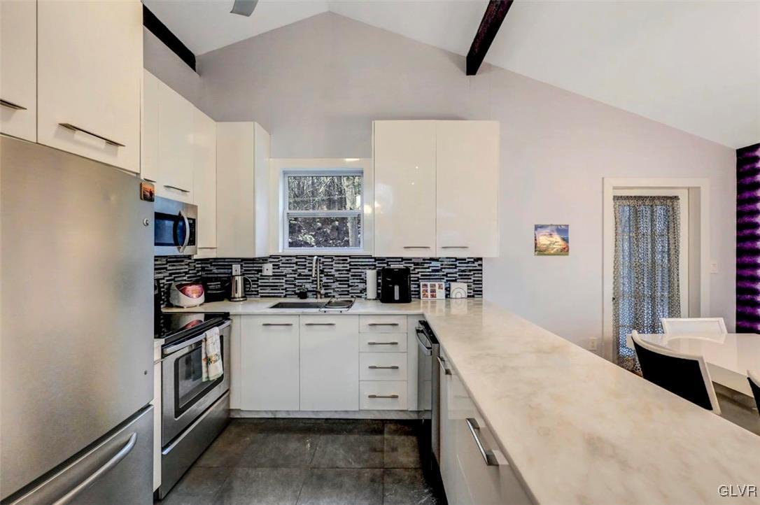 108 Sterling Circle Bushkill, PA 18324 - Photo 21 of 51 a kitchen with a stove top oven and cabinets