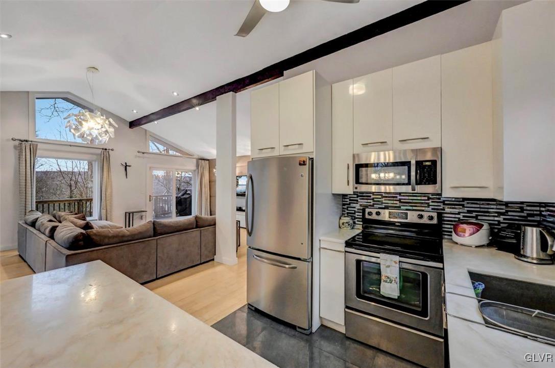 108 Sterling Circle Bushkill, PA 18324 - Photo 22 of 51 a kitchen with stainless steel appliances a refrigerator stove microwave and white cabinets