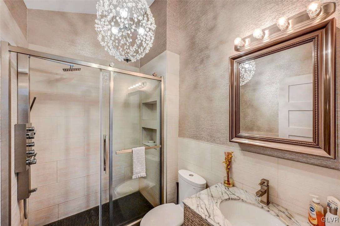 108 Sterling Circle Bushkill, PA 18324 - Photo 25 of 51 a bathroom with a granite countertop shower sink vanity and a mirror