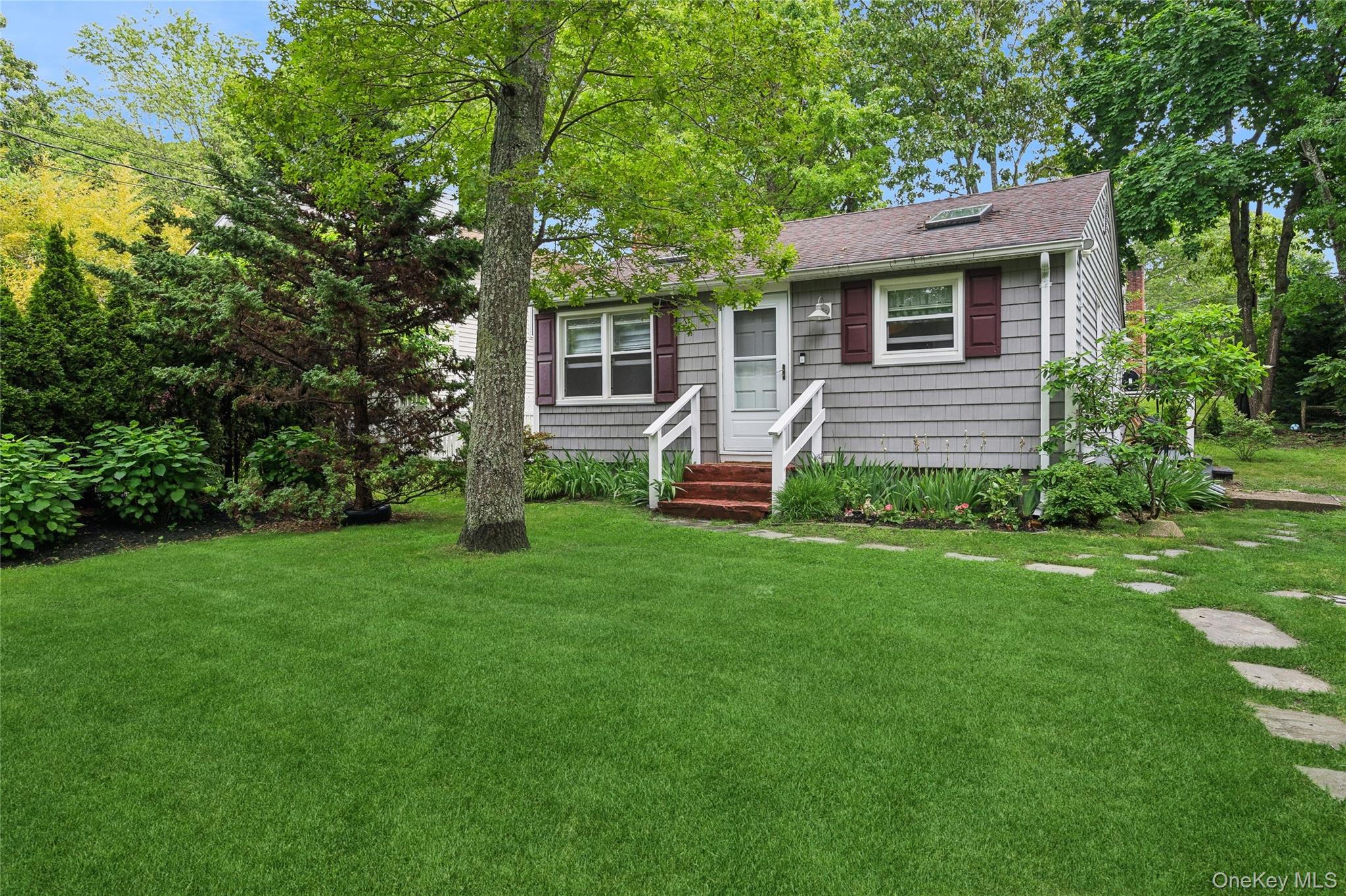 Bungalow-style home featuring a front yard and roof with shingles
