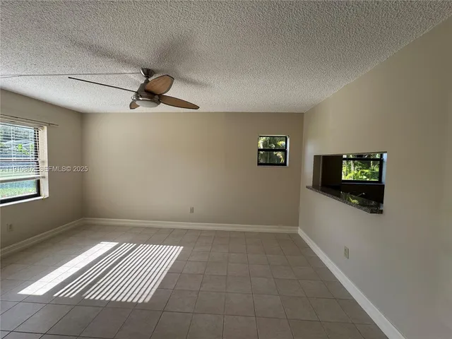a view of empty room with window and fireplace