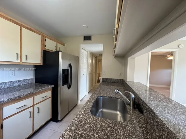 a kitchen with a sink and a refrigerator