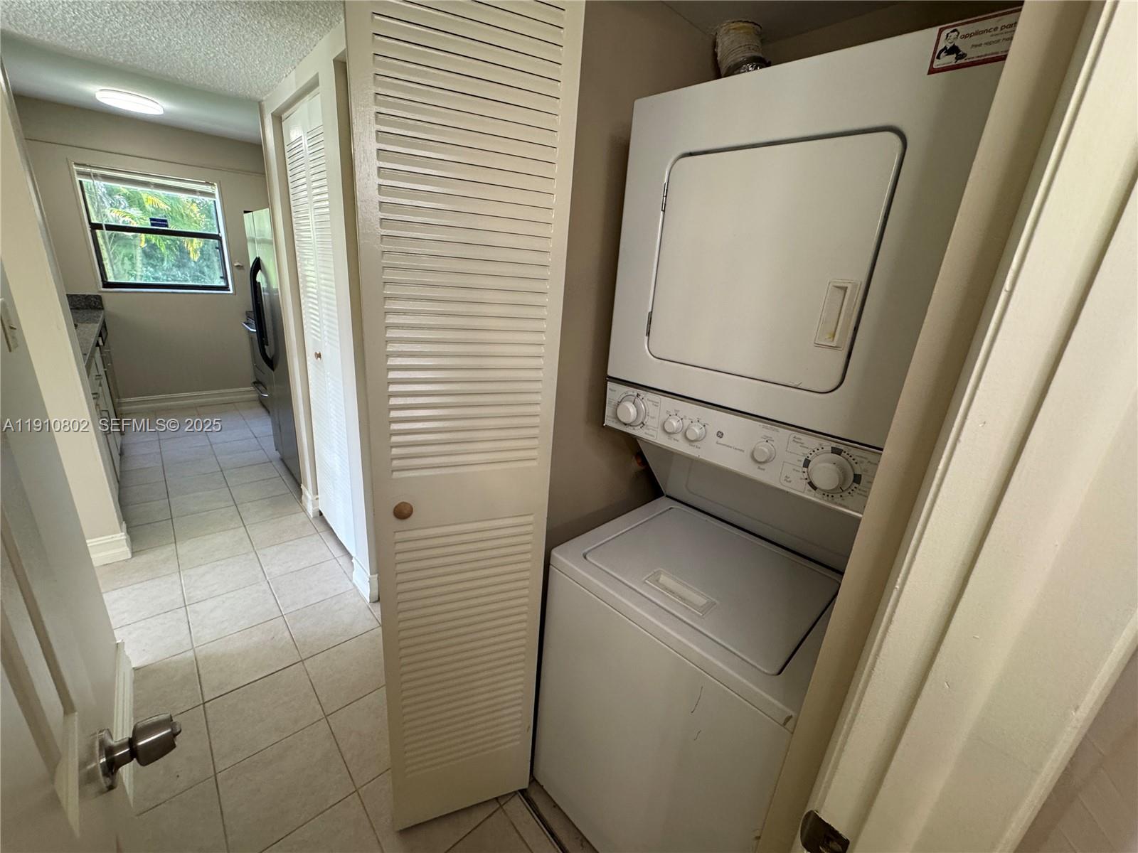6031 Shaker Wood Circle, Unit 101 Tamarac, FL 33319 - Photo 26 of 28 a utility room with dryer and washer