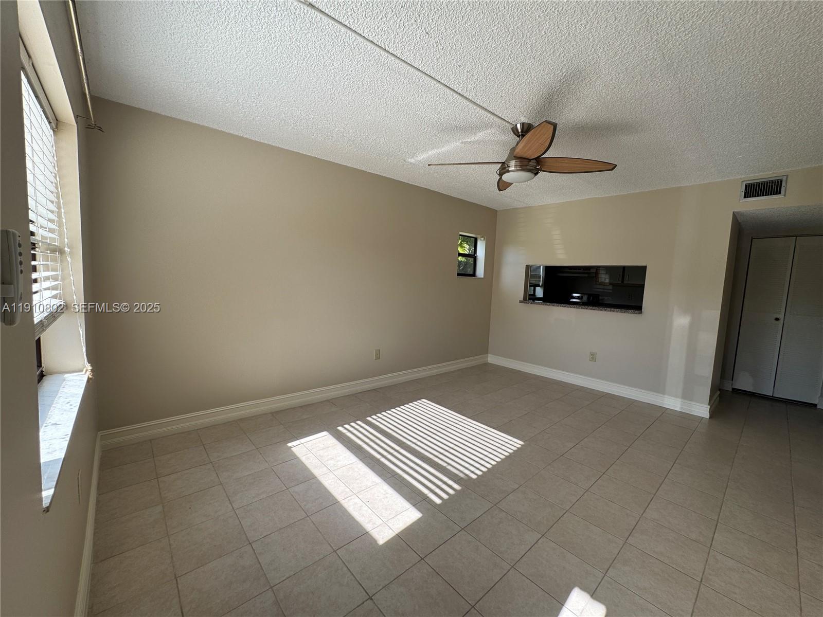 6031 Shaker Wood Circle, Unit 101 Tamarac, FL 33319 - Photo 5 of 28 a view of an empty room and a window