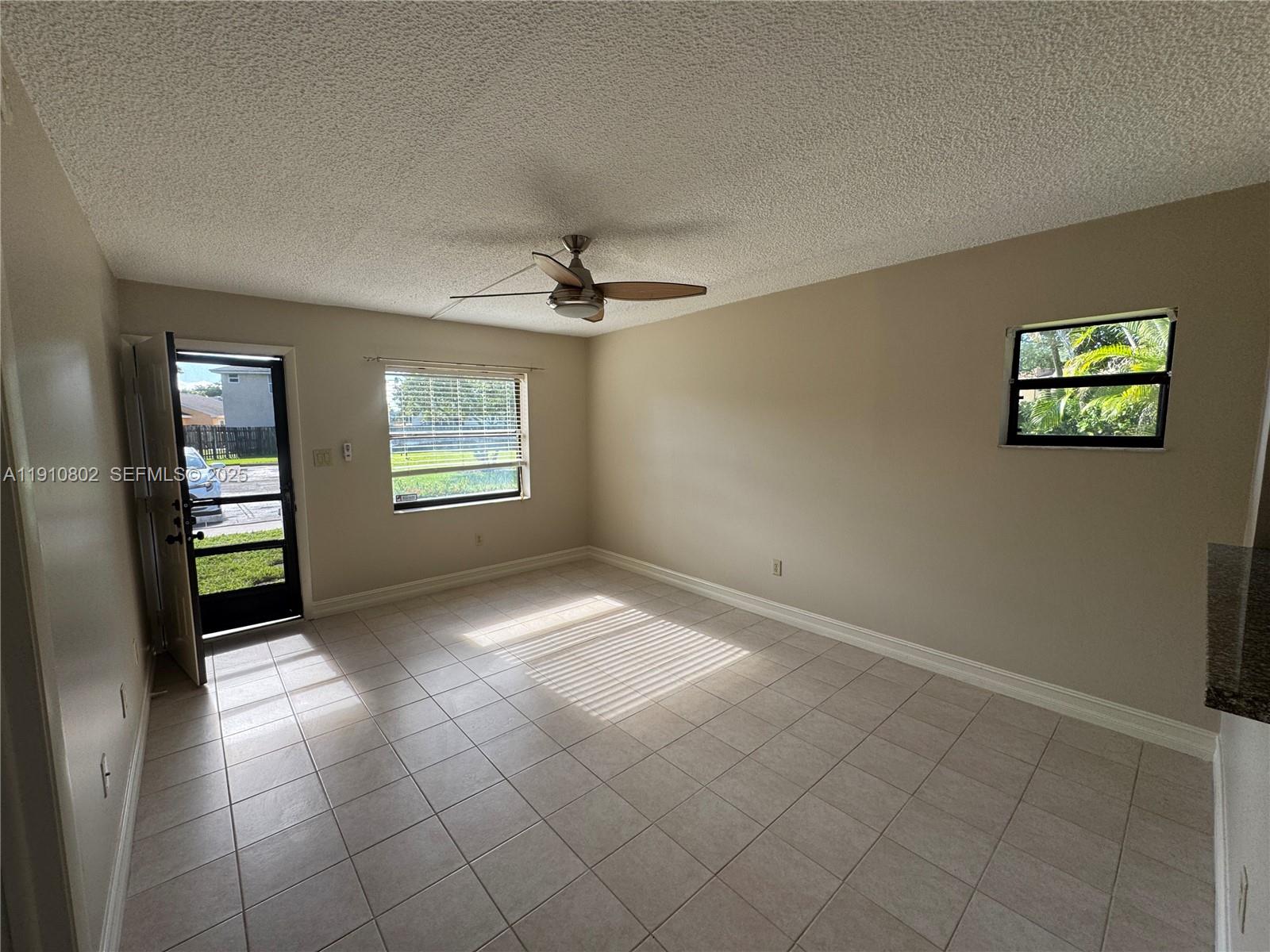6031 Shaker Wood Circle, Unit 101 Tamarac, FL 33319 - Photo 7 of 28 a view of an empty room with a window