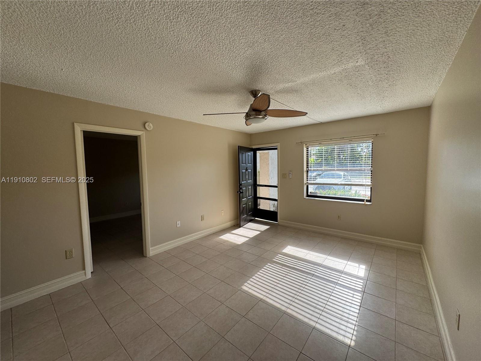 6031 Shaker Wood Circle, Unit 101 Tamarac, FL 33319 - Photo 8 of 28 a view of an empty room with a window