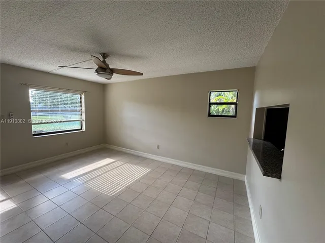 a view of an empty room and a window