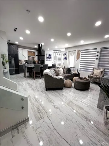 a kitchen with stainless steel appliances kitchen island granite countertop a sink and cabinets