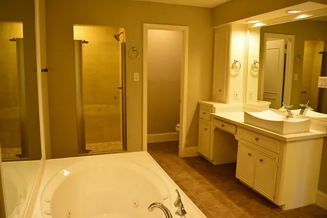 a bathroom with a tub and shower