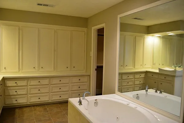 a bathroom with a tub and shower