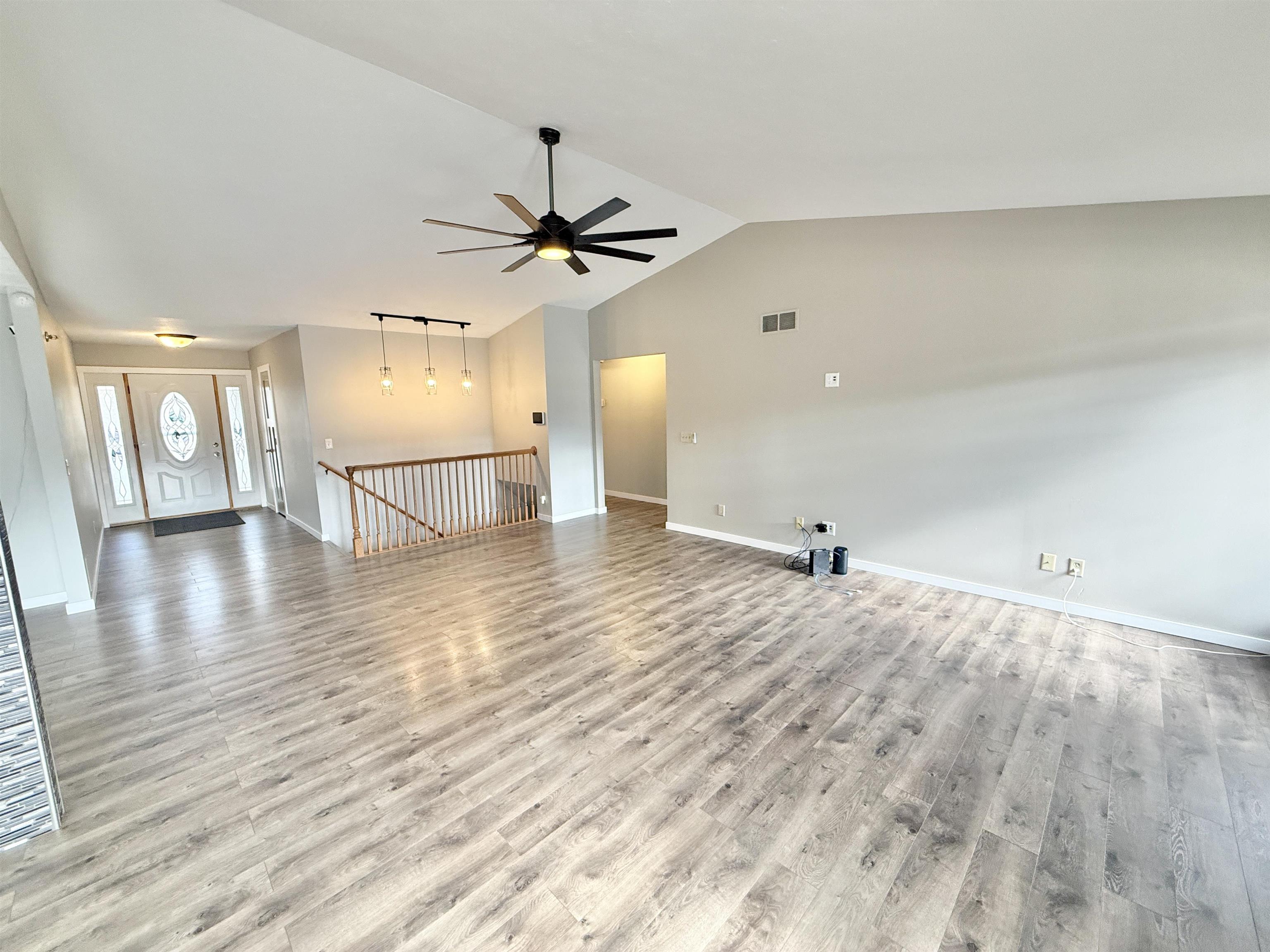 11008 Chicory Ridge Way Roscoe, IL 61073 - Photo 11 of 45 a view of an empty room and kitchen view with wooden floor