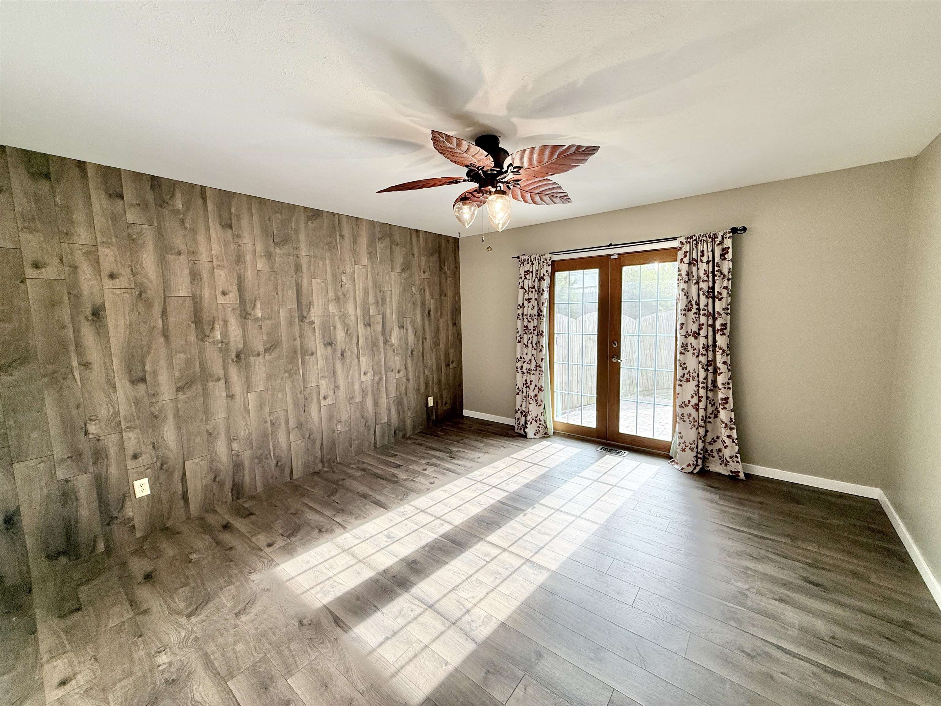 11008 Chicory Ridge Way Roscoe, IL 61073 - Photo 15 of 45 a view of a livingroom with wooden floor and a ceiling fan
