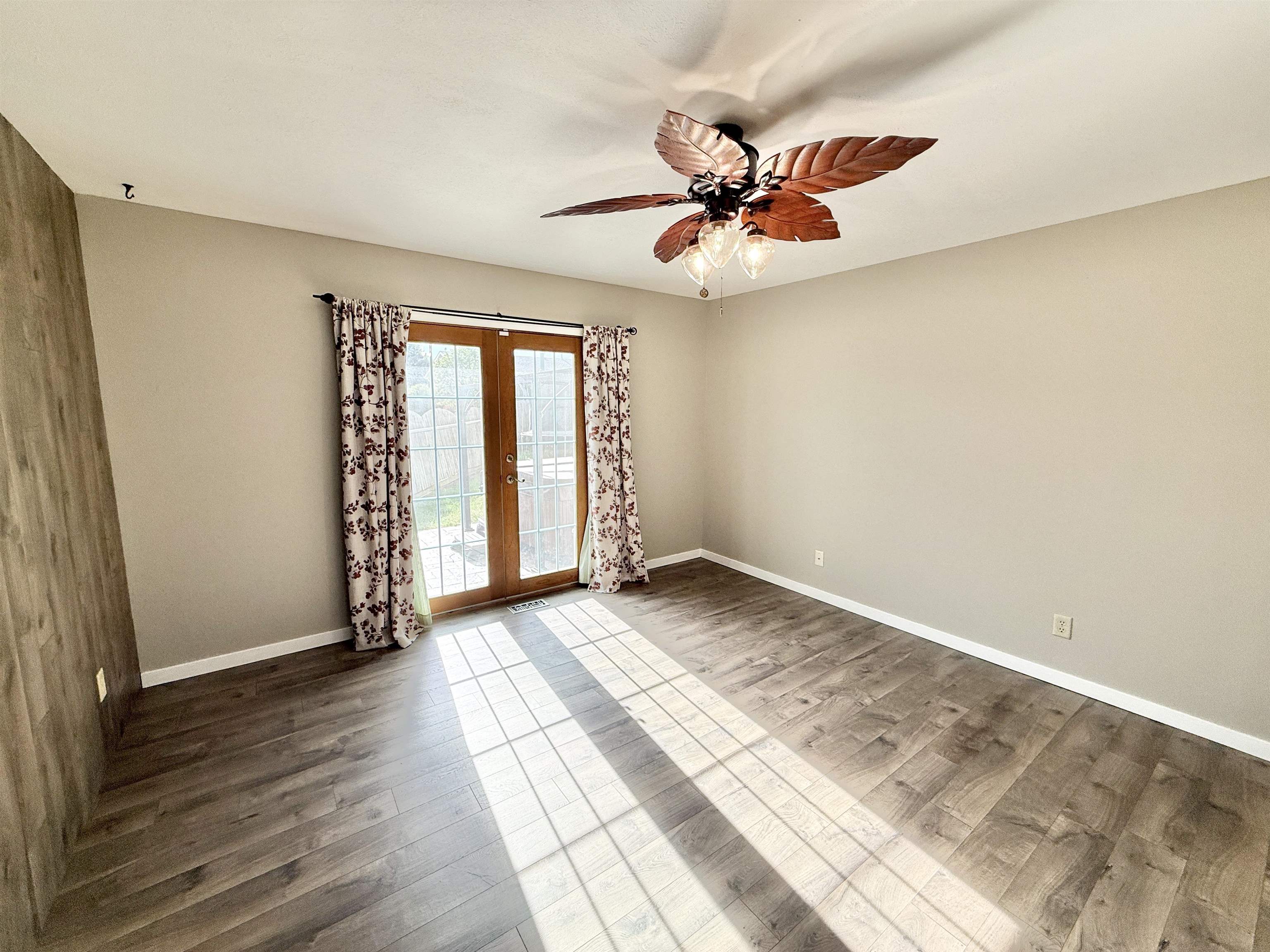 11008 Chicory Ridge Way Roscoe, IL 61073 - Photo 16 of 45 an empty room with wooden floor fan and windows