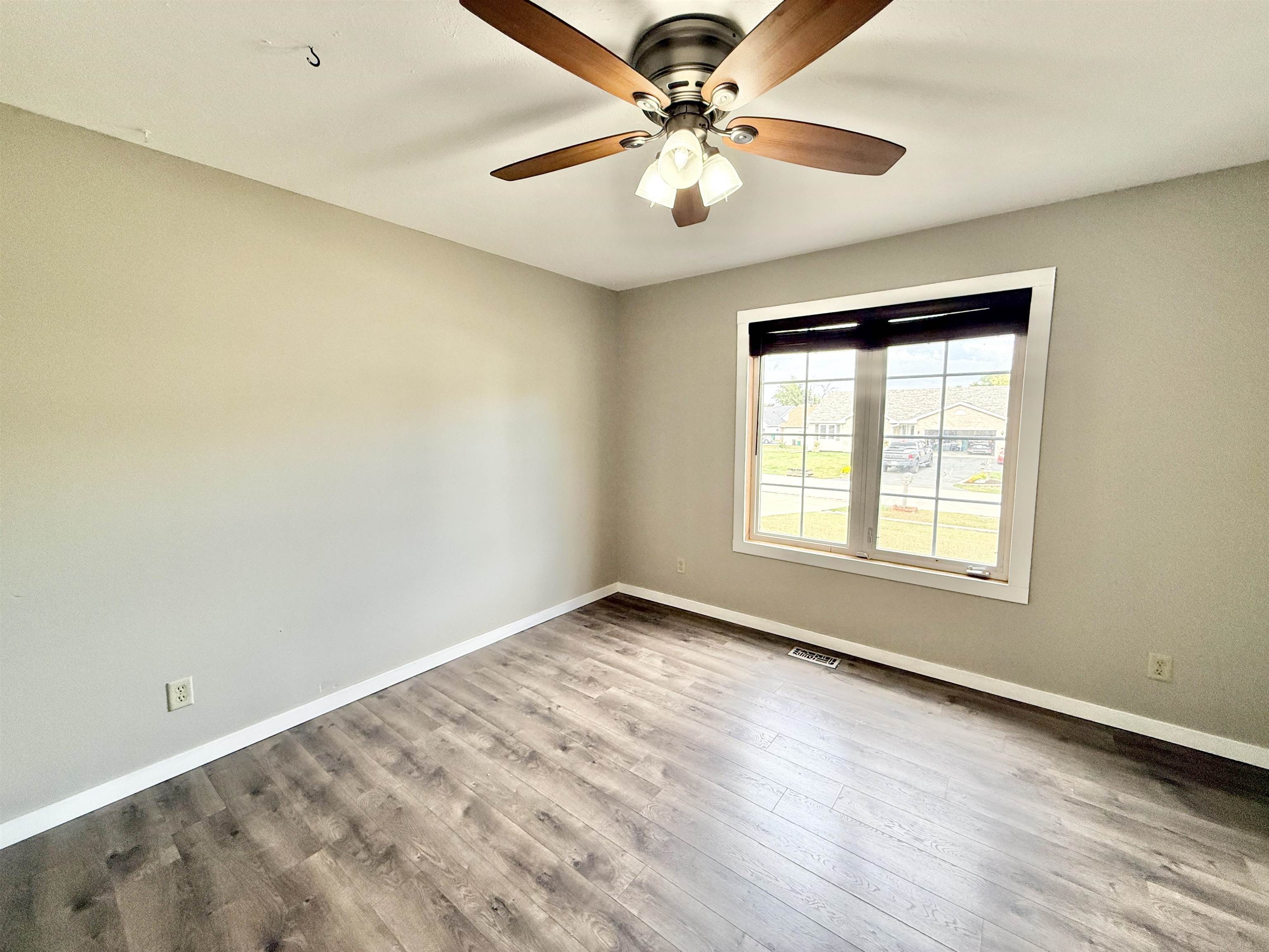 11008 Chicory Ridge Way Roscoe, IL 61073 - Photo 19 of 45 wooden floor in an empty room with a window