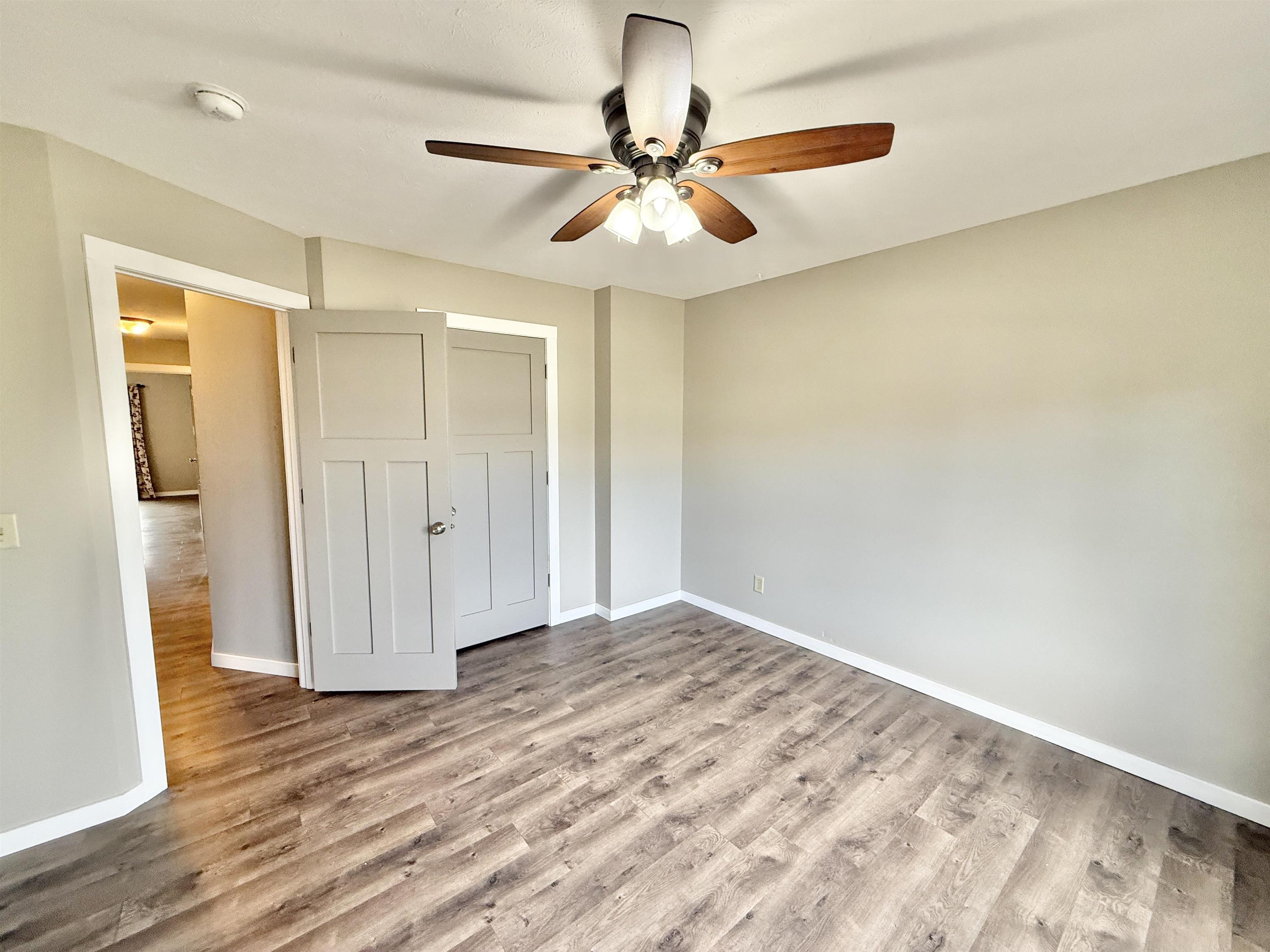 11008 Chicory Ridge Way Roscoe, IL 61073 - Photo 20 of 45 a view of a room with wooden floor and a ceiling fan