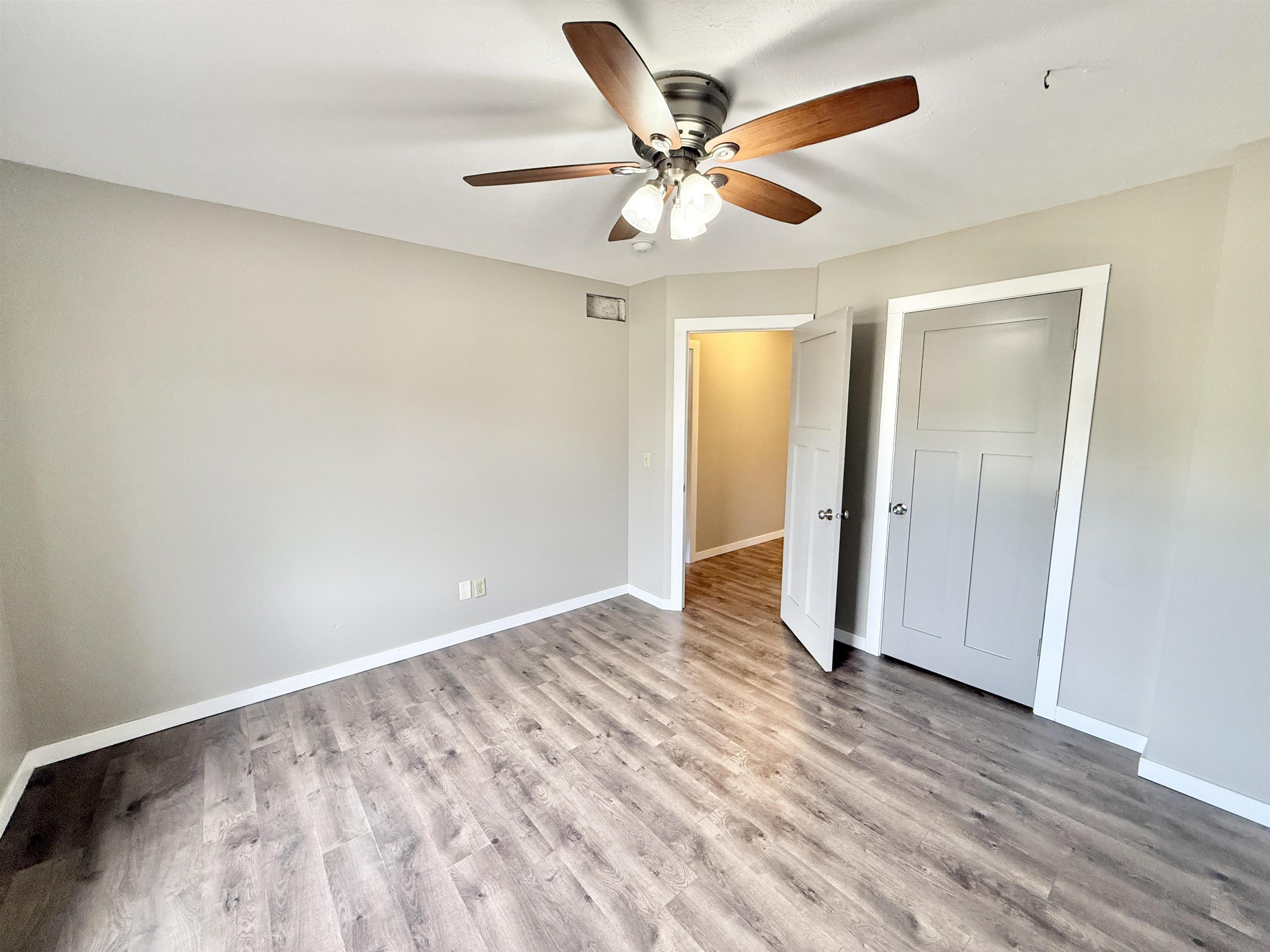 11008 Chicory Ridge Way Roscoe, IL 61073 - Photo 21 of 45 an empty room with wooden floor closet and ceiling fan