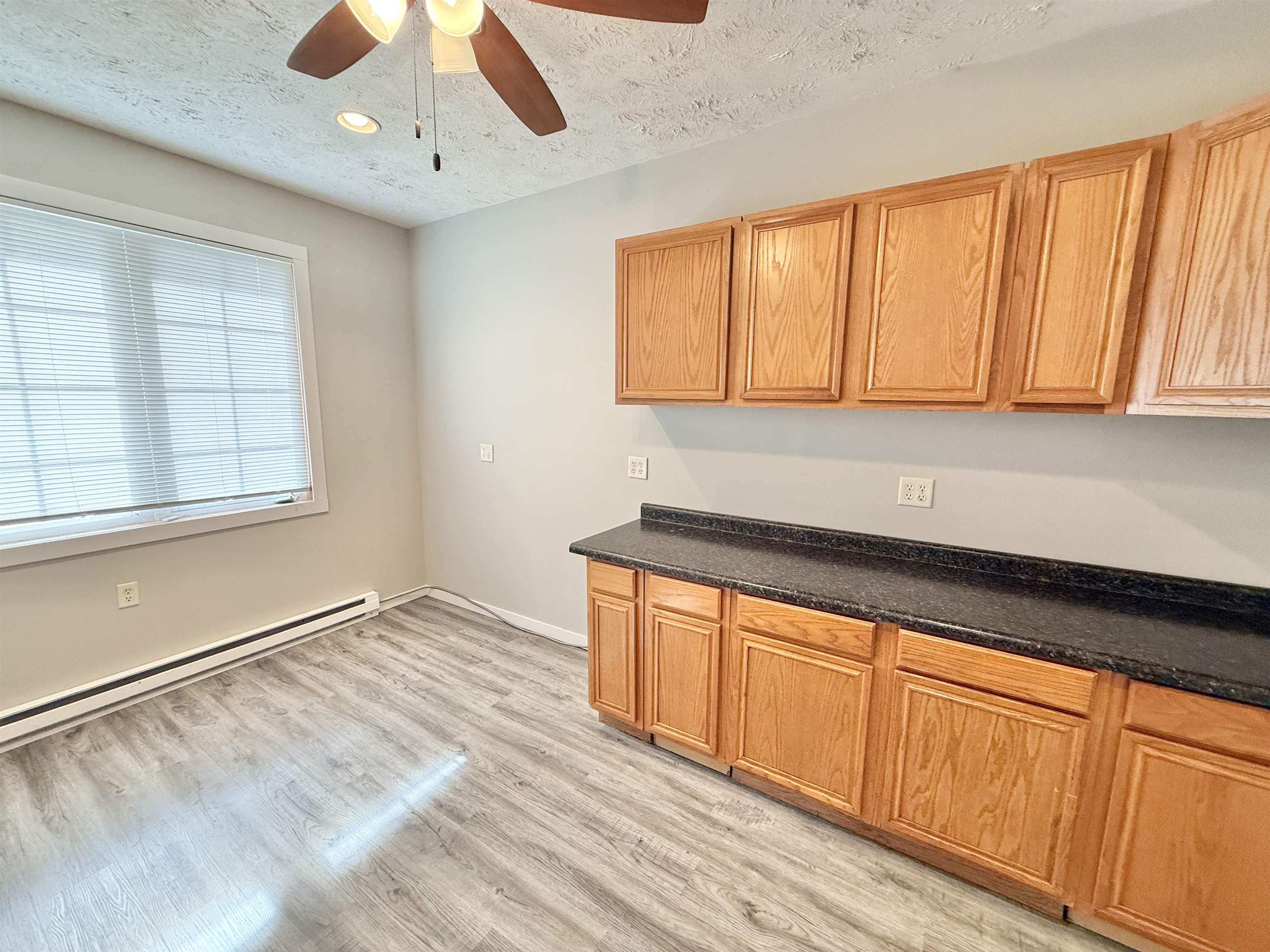 11008 Chicory Ridge Way Roscoe, IL 61073 - Photo 27 of 45 a kitchen with stainless steel appliances granite countertop a sink and cabinets with wooden floor