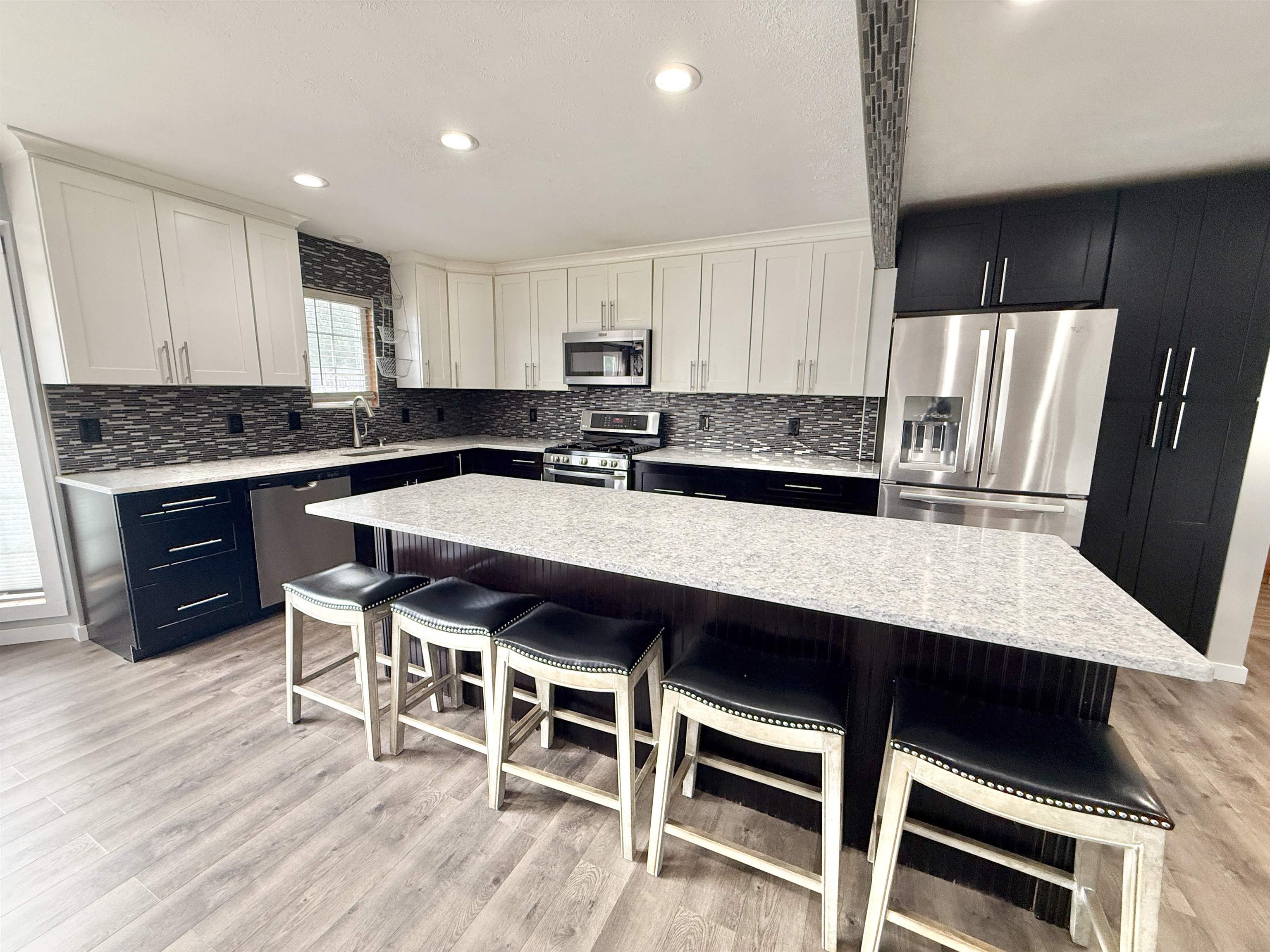 11008 Chicory Ridge Way Roscoe, IL 61073 - Photo 5 of 45 a kitchen with a dining table chairs and wooden floor