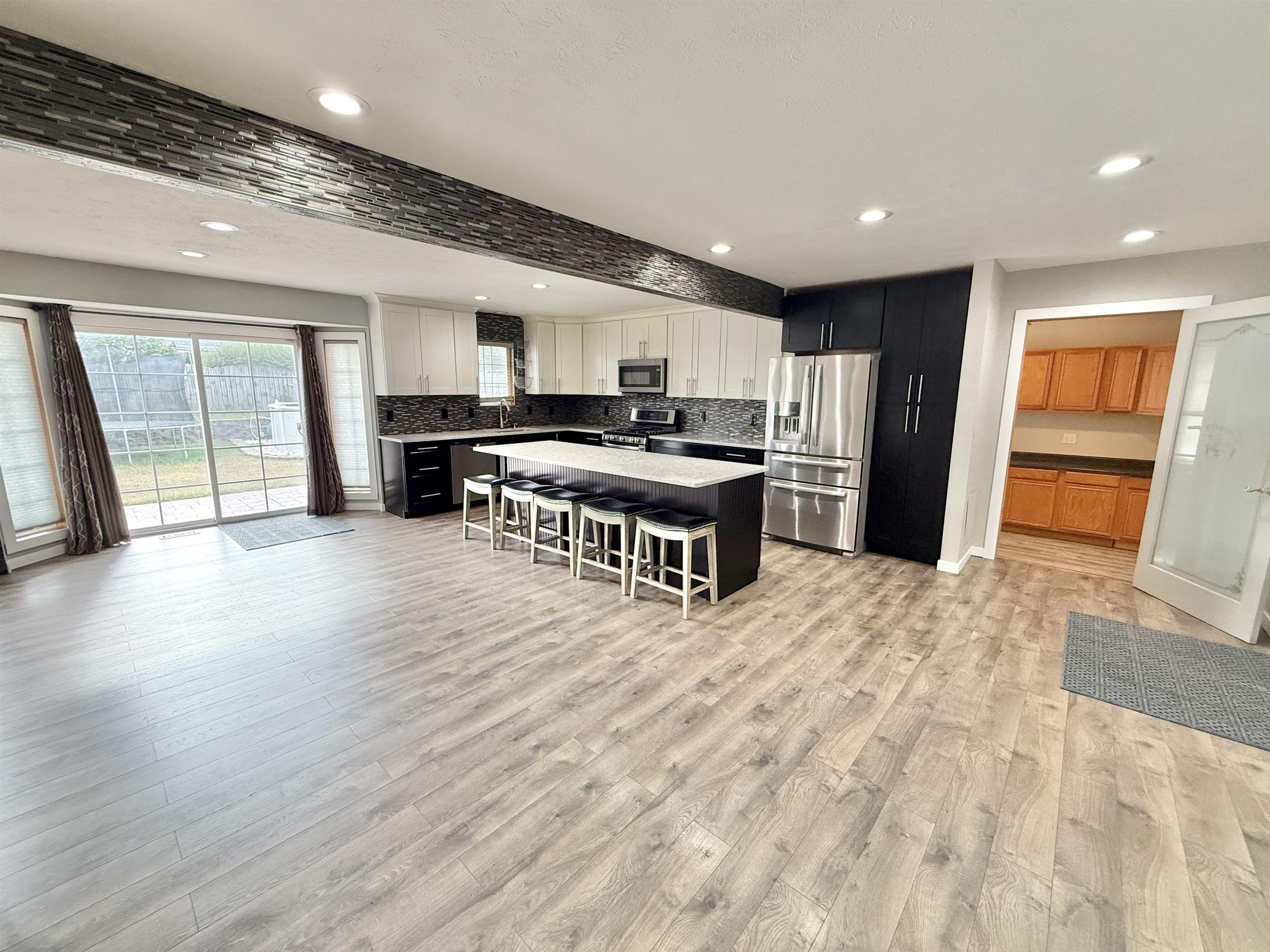 11008 Chicory Ridge Way Roscoe, IL 61073 - Photo 6 of 45 a large kitchen with stainless steel appliances granite countertop a stove and a wooden floors