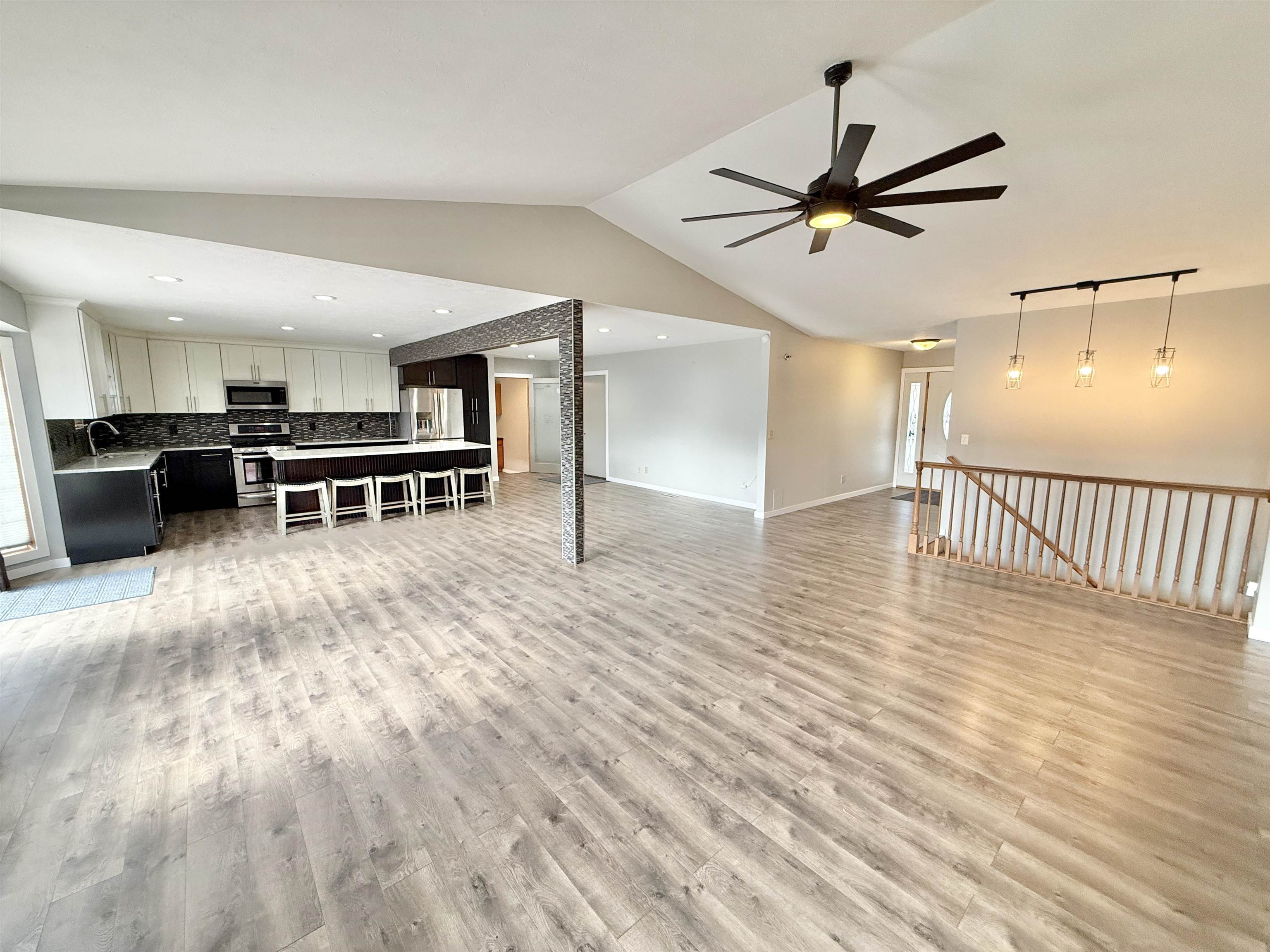 11008 Chicory Ridge Way Roscoe, IL 61073 - Photo 8 of 45 a view of a kitchen with kitchen island wooden floor and a ceiling fan