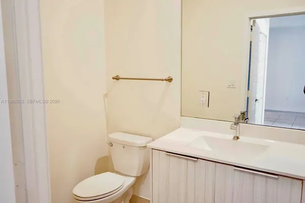 a white toilet sitting next to a bathroom sink