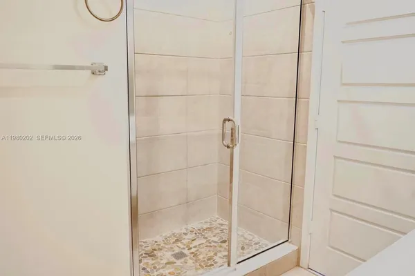 a bathroom with a glass shower door
