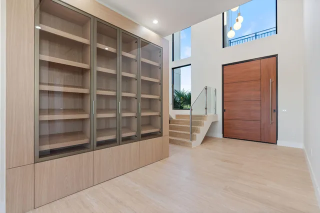 an empty room with windows and mirror