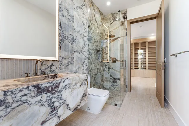 a view of an empty room with a cabinet and mirrors