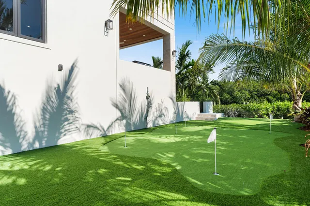 a view of kitchen with granite countertop cabinets and window