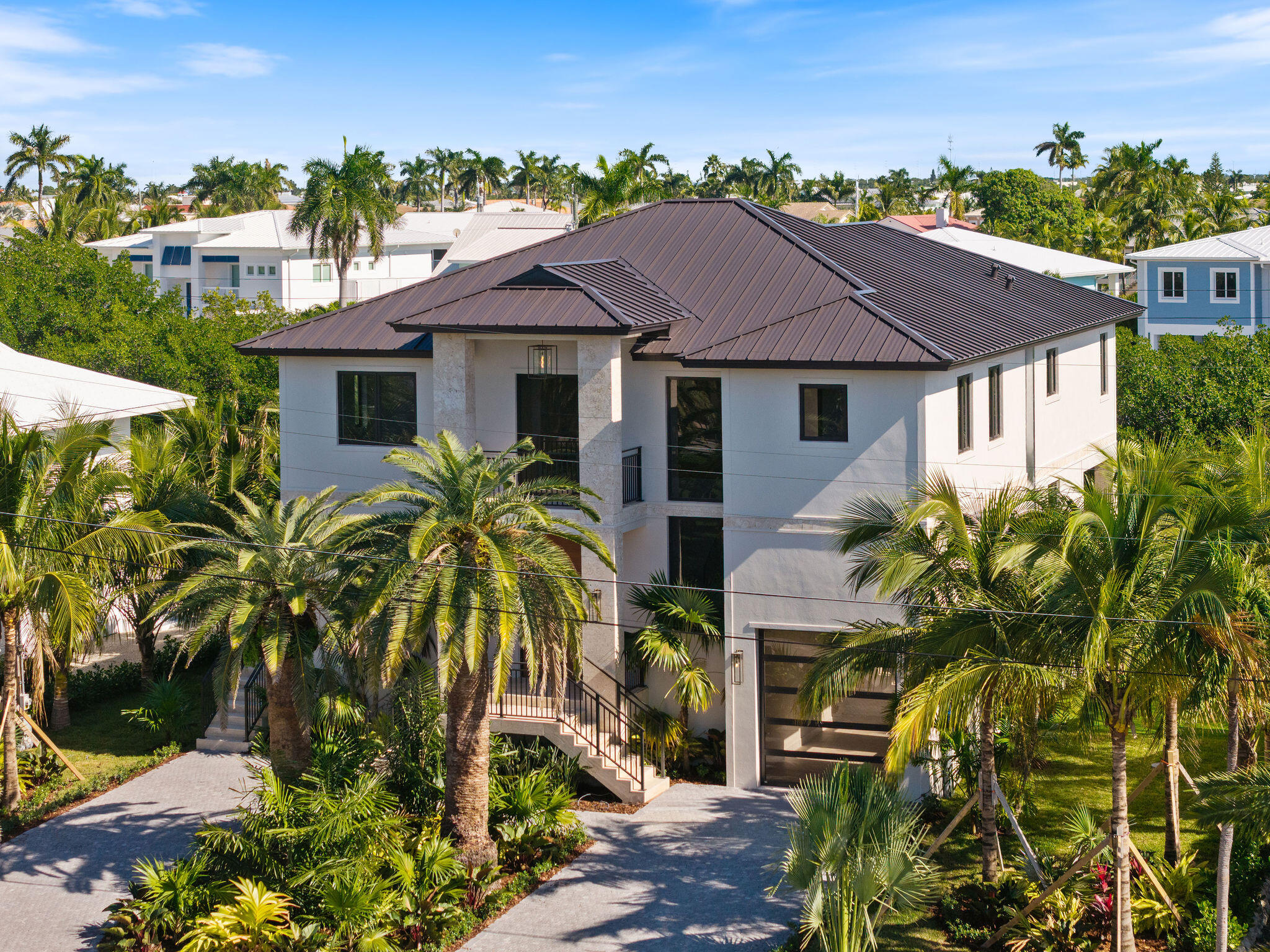 230 15th Circle Key Colony Beach, FL 33051 - Photo 87 of 103 a view of a white house with a yard and plants