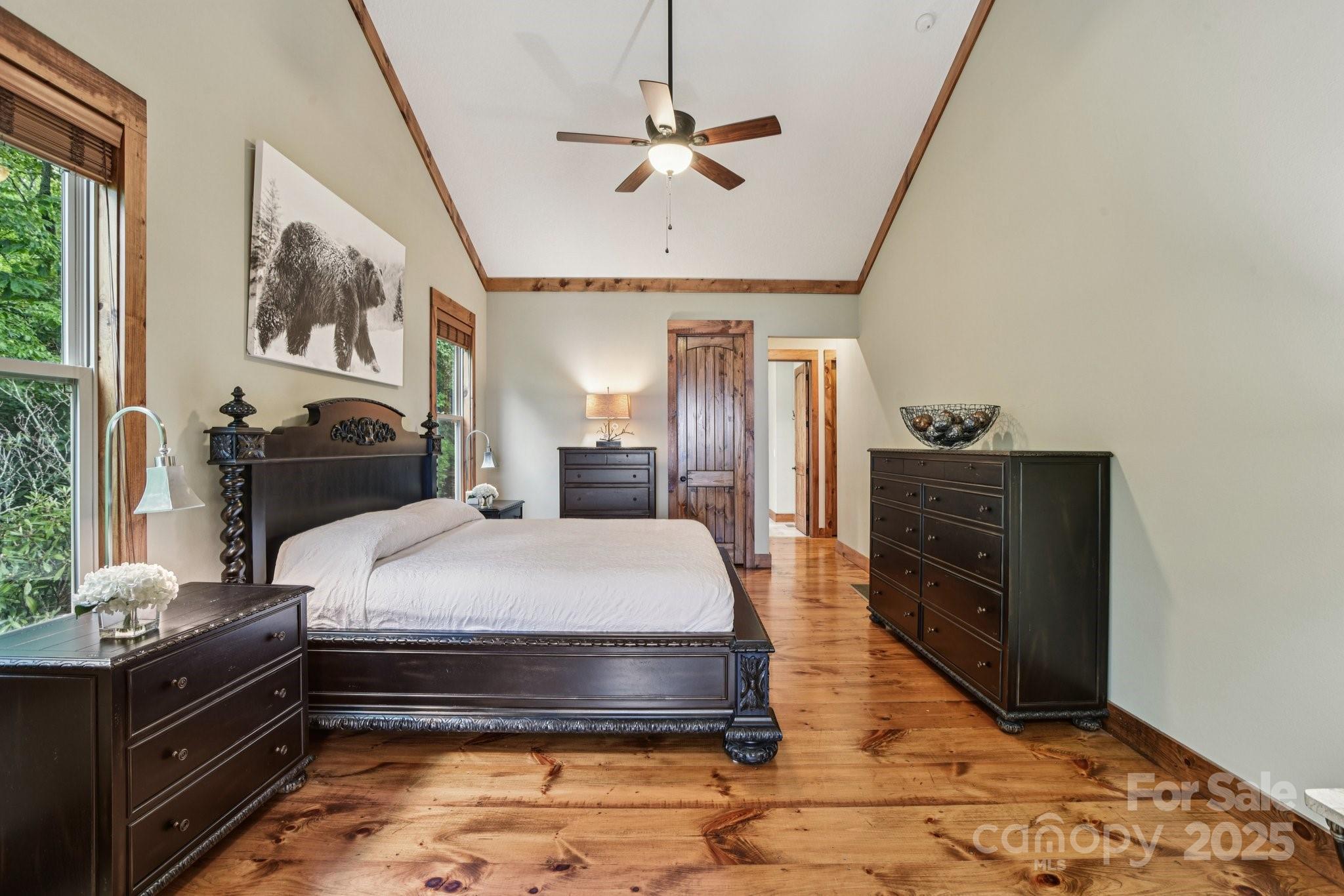 71 Raptor Way Sapphire, NC 28774 - Photo 22 of 46 a bedroom with a bed and wooden floor