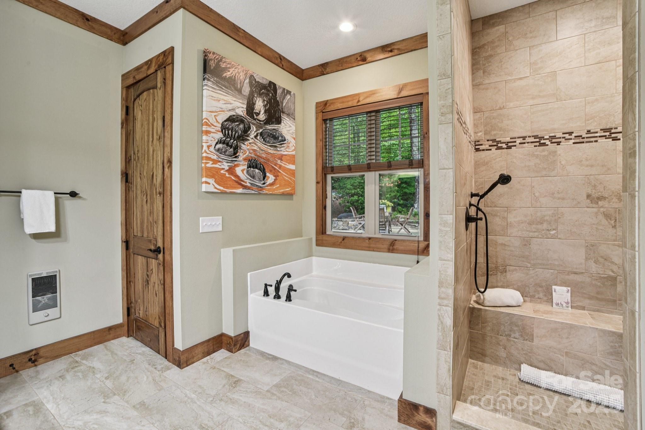 71 Raptor Way Sapphire, NC 28774 - Photo 26 of 46 a bathroom with a bathtub and shower