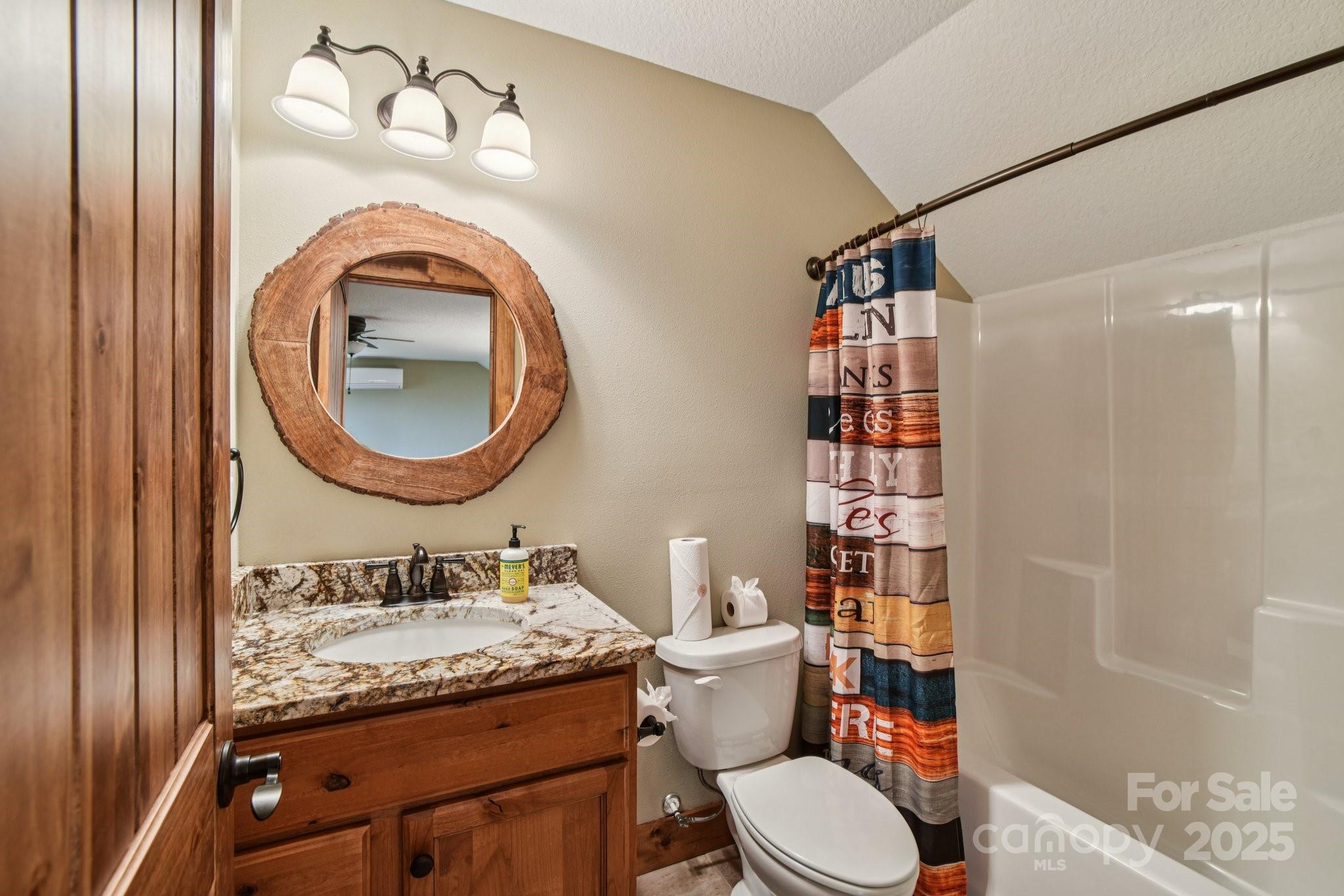 71 Raptor Way Sapphire, NC 28774 - Photo 32 of 46 a bathroom with a granite countertop toilet sink vanity and shower