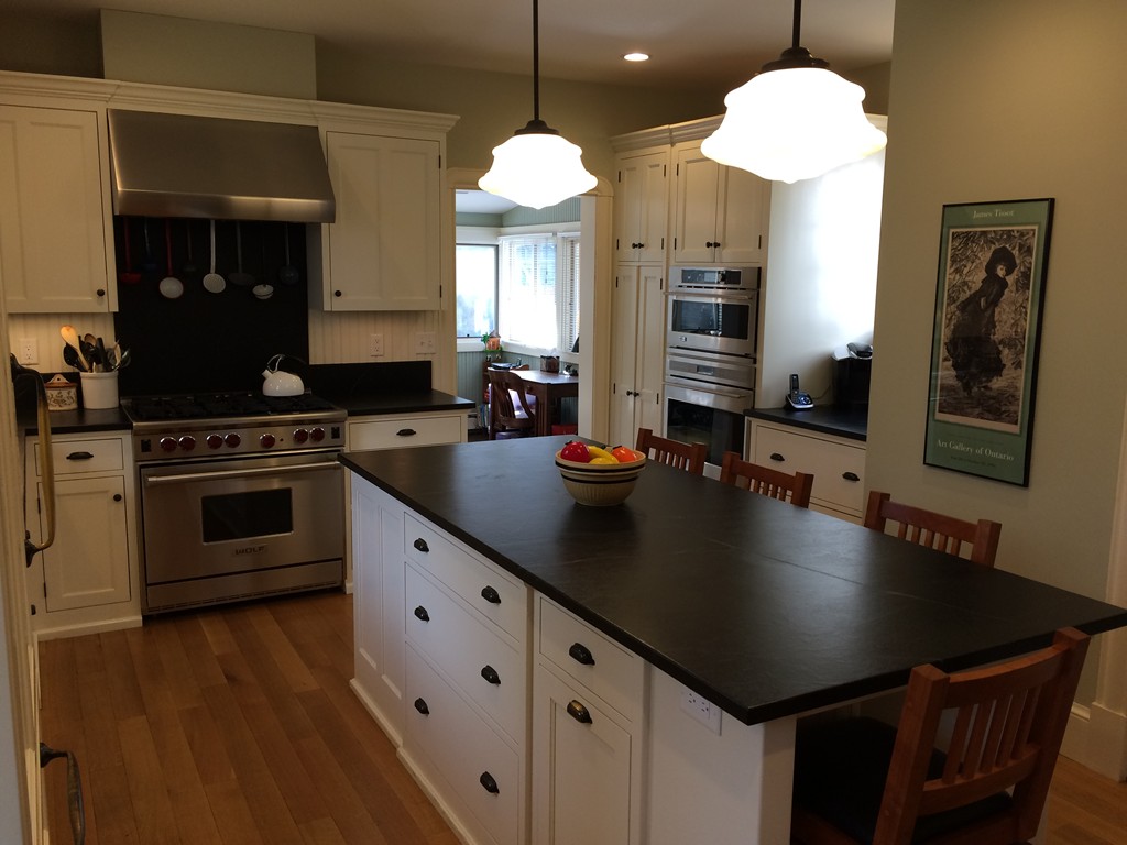 100 Salisbury Road Brookline, MA 02445 - Photo 2 of 22 a kitchen with stainless steel appliances a sink a stove and a wooden floor