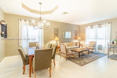 8525 Pine Cay West Palm Beach, FL 33411 - Photo 14 of 40 a living room with furniture a large window and a dining table