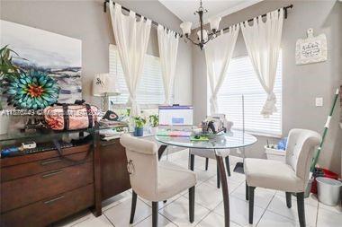8525 Pine Cay West Palm Beach, FL 33411 - Photo 15 of 40 a view of a dining room with furniture and window