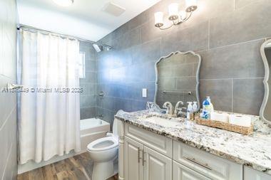 8525 Pine Cay West Palm Beach, FL 33411 - Photo 21 of 40 a bathroom with a granite countertop sink toilet and shower