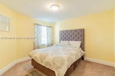 a bedroom with a bed and a night stand