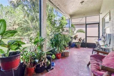 a living room filled with furniture and a potted plant